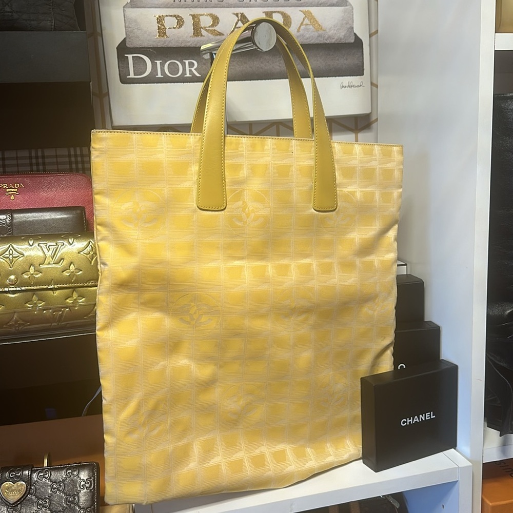 Chanel Tote bag New travel line yellow. Corners have tiny stains. Pre-loved.